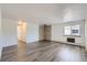 Large, open living area with laminate flooring and a brick accent wall at 62 Newark St # D, Aurora, CO 80012