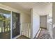 Outdoor patio with a sliding glass door and white railing, and a white exterior door at 62 Newark St # D, Aurora, CO 80012