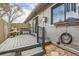 Relaxing outdoor space on a shaded back porch that includes a chair and decorative items at 4028 Ames St, Wheat Ridge, CO 80212