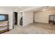 Spacious finished basement with carpet, shelving units and kitchenette at 4028 Ames St, Wheat Ridge, CO 80212
