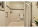Shower-tub features decorative tiling and silver hardware at 4028 Ames St, Wheat Ridge, CO 80212