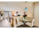 Bright dining area with glass table and modern pendant lighting, adjacent to the living room at 4028 Ames St, Wheat Ridge, CO 80212