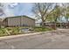 Maplewood Condominiums features a beautiful rock garden and manicured landscaping on a tree-lined street at 4028 Ames St, Wheat Ridge, CO 80212