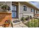 Charming front door with flower basket and brick accents, creating a welcoming entrance to the home at 4028 Ames St, Wheat Ridge, CO 80212