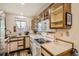 Functional kitchen featuring a stove, microwave, and classic cabinetry with ample counter space at 4028 Ames St, Wheat Ridge, CO 80212