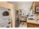 Efficient kitchen with stainless steel appliances and direct access to an in-unit washer and dryer at 4028 Ames St, Wheat Ridge, CO 80212