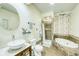 Unique bathroom boasts a vessel sink, circular mirror, walk-in shower, and soaking tub at 234 Carroll Ln, Breckenridge, CO 80424