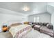 Bedroom with comfy queen bed, seating area with leather couch, and carpeted floors at 234 Carroll Ln, Breckenridge, CO 80424