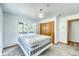 Cozy bedroom features a white metal frame bed, natural light, and a built-in closet at 234 Carroll Ln, Breckenridge, CO 80424
