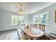 Sun-filled dining area with a chandelier and stunning mountain views at 234 Carroll Ln, Breckenridge, CO 80424