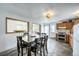 The dining room features an expansive dining table, adjacent to the rustic kitchen area with stone floors at 234 Carroll Ln, Breckenridge, CO 80424