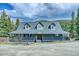 Charming two-story home with a covered porch nestled among mature trees at 234 Carroll Ln, Breckenridge, CO 80424