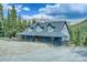 Charming home boasts a gray exterior, spacious porch, and a scenic mountain backdrop at 234 Carroll Ln, Breckenridge, CO 80424