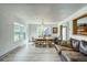 Bright living room with wood floors, large windows, and elegant dining chandelier at 234 Carroll Ln, Breckenridge, CO 80424