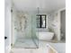 Stunning bathroom with marble tile, a freestanding tub, and glass-enclosed shower at 5326 Lions Paw St, Castle Rock, CO 80104
