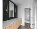 Modern bathroom featuring vanity, stylish mirror, sconces and walk-in shower at 5326 Lions Paw St, Castle Rock, CO 80104