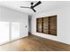Bright bedroom with hardwood floors, a modern ceiling fan, and custom built-in shelving at 5326 Lions Paw St, Castle Rock, CO 80104