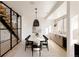 Contemporary dining room featuring a long white table, black chairs, and modern lighting at 5326 Lions Paw St, Castle Rock, CO 80104