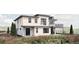 Back exterior view showcasing modern design with second story balcony and mountain views in the background at 5326 Lions Paw St, Castle Rock, CO 80104