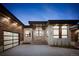 Modern exterior with stone accents, wood siding, and dark trim under a twilight sky at 5326 Lions Paw St, Castle Rock, CO 80104