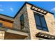Detail of the home's stone and wood exterior, showcasing modern design elements at 5326 Lions Paw St, Castle Rock, CO 80104