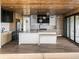 Spacious kitchen with wood paneled ceilings, stainless steel appliances, and a large center island with a breakfast bar at 5326 Lions Paw St, Castle Rock, CO 80104