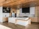 Spacious kitchen with wood paneled ceilings, stainless steel appliances, and a large center island with a breakfast bar at 5326 Lions Paw St, Castle Rock, CO 80104