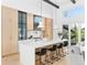 Spacious kitchen with a large island, modern light fixtures, spiral staircase, and stylish bar stools at 5326 Lions Paw St, Castle Rock, CO 80104