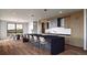 Open concept kitchen features a large island with seating and modern appliances next to the breakfast nook at 5326 Lions Paw St, Castle Rock, CO 80104