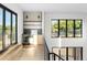 Open landing area with a wet bar, built-in shelving, and large windows offering natural light at 5326 Lions Paw St, Castle Rock, CO 80104