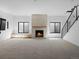 Spacious living room with fireplace, large windows, and plush carpet at 5326 Lions Paw St, Castle Rock, CO 80104