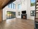 Bright living room with hardwood floors, fireplace, and large windows with sliding doors to the outside at 5326 Lions Paw St, Castle Rock, CO 80104