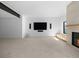 Living room with fireplace, TV, speakers, and bright natural light at 5326 Lions Paw St, Castle Rock, CO 80104