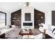 Elegant living room features a fireplace, wood-paneled walls, and stylish decor at 5326 Lions Paw St, Castle Rock, CO 80104