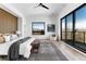 Bright main bedroom with a large window, wood floors, and stylish furnishings at 5326 Lions Paw St, Castle Rock, CO 80104