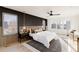 Modern main bedroom with black accent wall, light wood floors, and neutral toned decor at 5326 Lions Paw St, Castle Rock, CO 80104