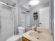 Bathroom featuring a shower, toilet, sink, and mirrored vanity at 5976 S Jellison St # E, Littleton, CO 80123