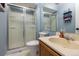 Bathroom featuring a frosted glass enclosed shower and functional vanity at 5976 S Jellison St # E, Littleton, CO 80123