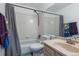 Bright bathroom featuring a shower-tub combo and a neutral-toned vanity at 5976 S Jellison St # E, Littleton, CO 80123