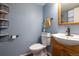Charming powder room with a vessel sink, and decorative accents offering practical convenience at 5976 S Jellison St # E, Littleton, CO 80123