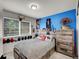 Bright bedroom with blue accent wall, rustic wooden furniture, and decorative sports-themed items displayed at 5976 S Jellison St # E, Littleton, CO 80123