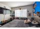 Cozy bedroom with natural light and wall-mounted TV, providing a relaxing and entertaining retreat at 5976 S Jellison St # E, Littleton, CO 80123