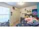 Bright bedroom with a large window, sliding closet, and fun accents create an inviting space at 5976 S Jellison St # E, Littleton, CO 80123