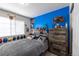 Vibrant bedroom, with blue accent wall, offers a playful and inspiring space for creativity and fun at 5976 S Jellison St # E, Littleton, CO 80123