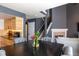 Elegant dining room showcases stylish furnishings, wood floors, an open staircase, and seamlessly adjoins the kitchen at 5976 S Jellison St # E, Littleton, CO 80123