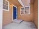 Welcoming entrance with a vivid blue door, complemented by natural lighting and a neutral exterior at 5976 S Jellison St # E, Littleton, CO 80123