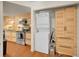 View of the kitchen and laundry area with stainless steel appliances and stackable washer and dryer at 5976 S Jellison St # E, Littleton, CO 80123