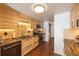 Well-equipped kitchen features wood cabinetry, stainless steel appliances, granite countertops, and tiled backsplash at 5976 S Jellison St # E, Littleton, CO 80123