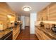 Well-equipped kitchen features wood cabinetry, stainless steel appliances, granite countertops, and tiled backsplash at 5976 S Jellison St # E, Littleton, CO 80123