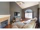 Inviting living room features a vaulted ceiling, fireplace, plush seating, and a large window that offers ample light at 5976 S Jellison St # E, Littleton, CO 80123